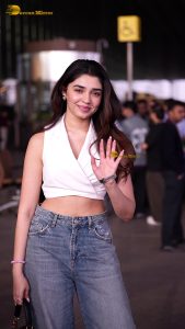 telugu actress Krithi Shetty cute in a white top and blue denim jeans