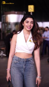 telugu actress Krithi Shetty cute in a white top and blue denim jeans