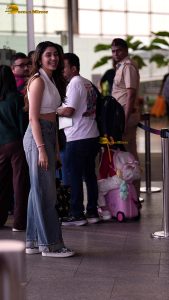 telugu actress Krithi Shetty cute in a white top and blue denim jeans
