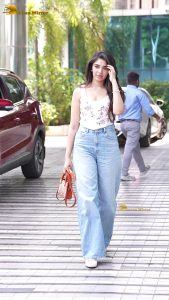 actress krithi shetty pretty in a white top and denim jeans