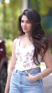 actress krithi shetty pretty in a white top and denim jeans