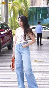 actress krithi shetty pretty in a white top and denim jeans