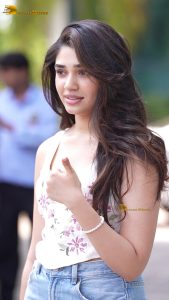 actress krithi shetty pretty in a white top and denim jeans