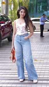 actress krithi shetty pretty in a white top and denim jeans