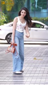actress krithi shetty pretty in a white top and denim jeans