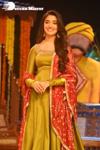 Actress Krithi Shetty dressed in a green Salwar Kameez dress while attending Bangarraju movie funciton