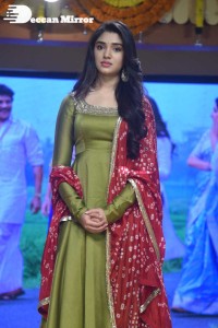 Actress Krithi Shetty dressed in a green Salwar Kameez dress while attending Bangarraju movie funciton