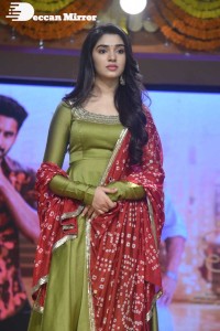 Actress Krithi Shetty dressed in a green Salwar Kameez dress while attending Bangarraju movie funciton