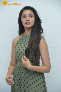Krithi Shetty poses for pictures in a green dress