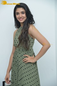 Krithi Shetty poses for pictures in a green dress