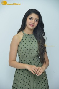Krithi Shetty poses for pictures in a green dress