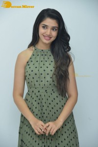 Krithi Shetty poses for pictures in a green dress