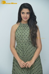 Krithi Shetty poses for pictures in a green dress