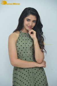 Krithi Shetty poses for pictures in a green dress