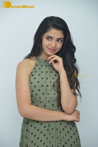 Krithi Shetty poses for pictures in a green dress