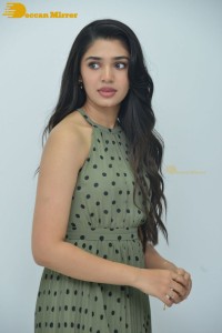 Krithi Shetty poses for pictures in a green dress