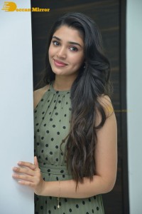 Krithi Shetty poses for pictures in a green dress