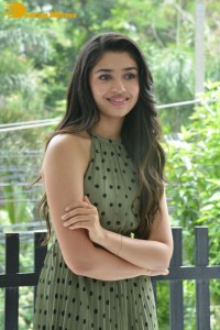 Krithi Shetty poses for pictures in a green dress