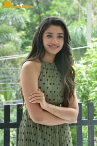 Krithi Shetty poses for pictures in a green dress
