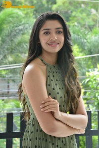 Krithi Shetty poses for pictures in a green dress