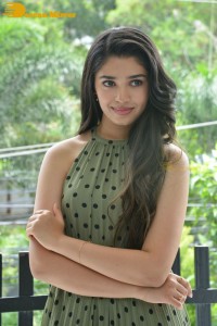 Krithi Shetty poses for pictures in a green dress