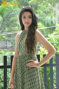 Krithi Shetty poses for pictures in a green dress