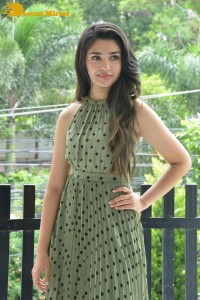 Krithi Shetty poses for pictures in a green dress