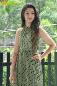 Krithi Shetty poses for pictures in a green dress