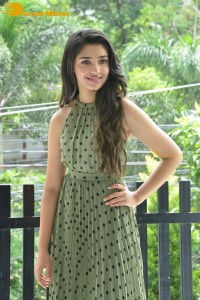 Krithi Shetty poses for pictures in a green dress