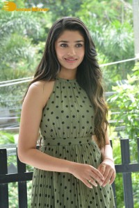 Krithi Shetty poses for pictures in a green dress