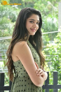 Krithi Shetty poses for pictures in a green dress