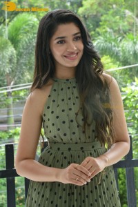 Krithi Shetty poses for pictures in a green dress