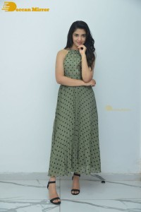 Krithi Shetty poses for pictures in a green dress