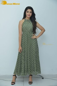 Krithi Shetty poses for pictures in a green dress