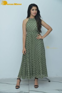 Krithi Shetty poses for pictures in a green dress