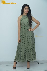 Krithi Shetty poses for pictures in a green dress