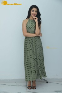 Krithi Shetty poses for pictures in a green dress