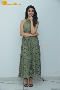 Krithi Shetty poses for pictures in a green dress