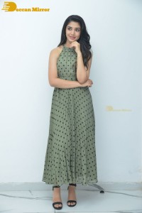 Krithi Shetty poses for pictures in a green dress