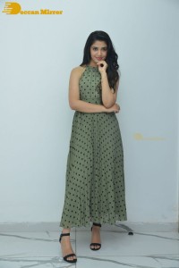 Krithi Shetty poses for pictures in a green dress