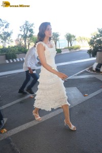 Indian actress Kriti Sanon in a white dress at mumbai airport