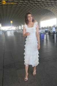 Indian actress Kriti Sanon in a white dress at mumbai airport