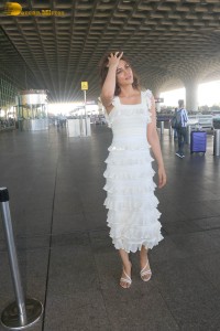 Indian actress Kriti Sanon in a white dress at mumbai airport