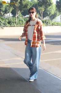 actress Kriti Sanon in a colorful shirt and denim jeans