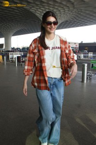 actress Kriti Sanon in a colorful shirt and denim jeans