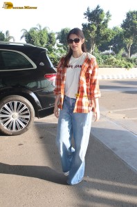 actress Kriti Sanon in a colorful shirt and denim jeans
