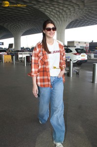 actress Kriti Sanon in a colorful shirt and denim jeans
