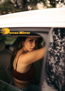 Lavanya Tripathi posing for pictures in a car