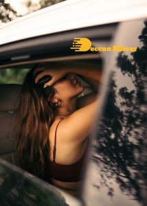 Lavanya Tripathi posing for pictures in a car