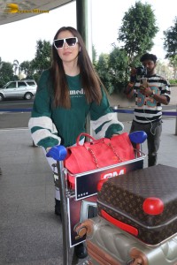 Actress Laxmi Raai in a green sweater at Mumbai Airport